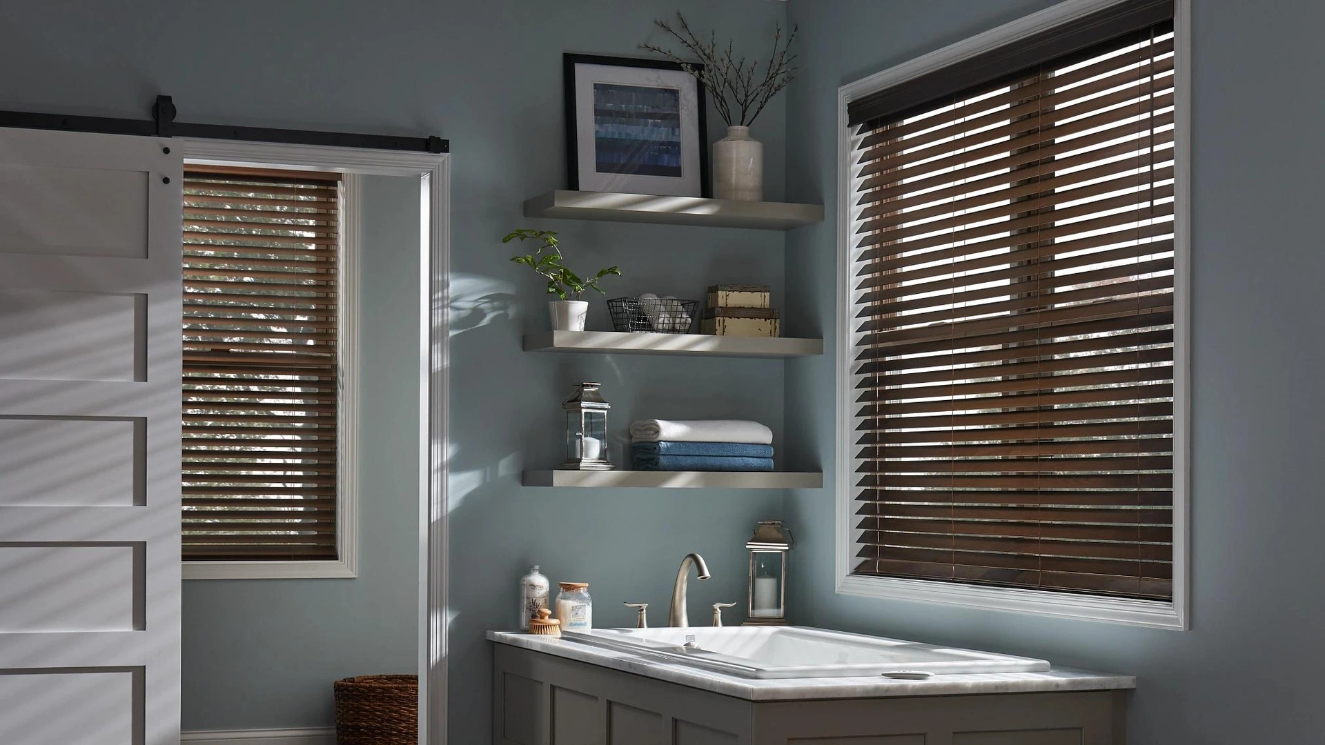 Stained Alta wood blinds in the manufacturer's blue bathroom setting.