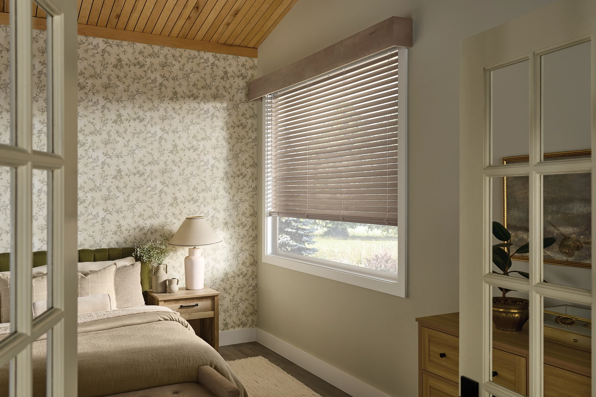 Graber wood blinds and cornice in a pale bedroom.