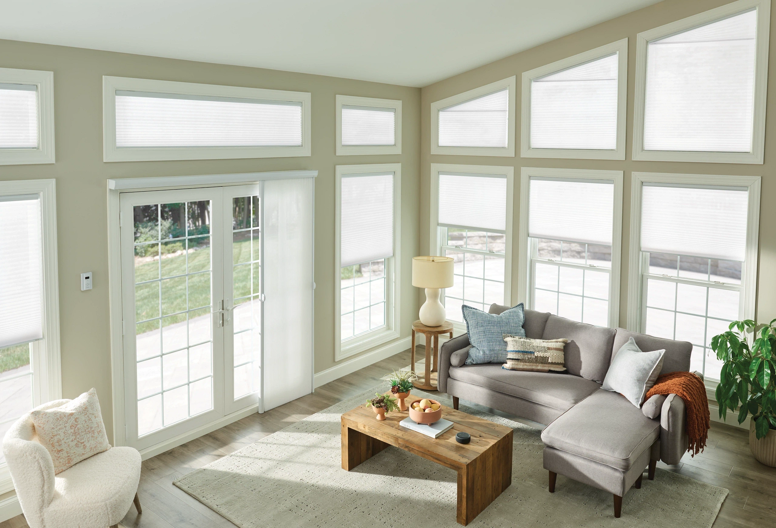 Custom Graber cellular shades and vertical honeycomb shades professionally installed in a sunroom.