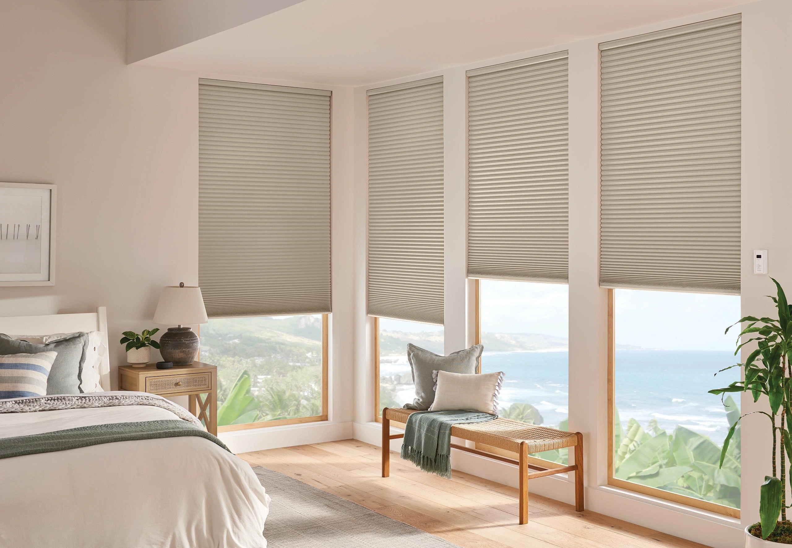 Custom Graber cellular shades and ivory drapery installed in a modern bedroom