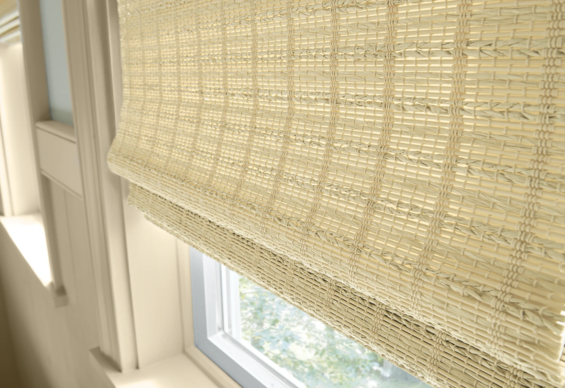 The texture of Graber Natural Woven Wood shades at a window.